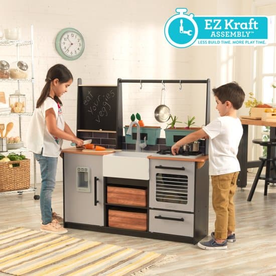 Two children play with the educational play kitchen farm to table from kidkraft
