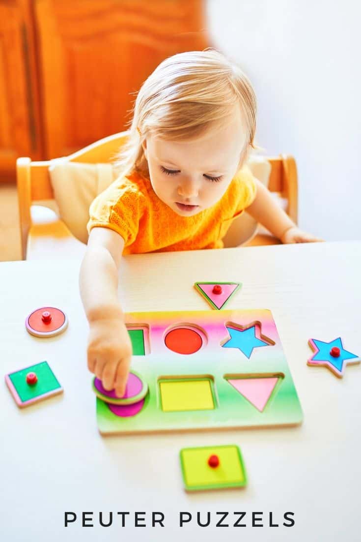 Toddler plays with puzzle at the table