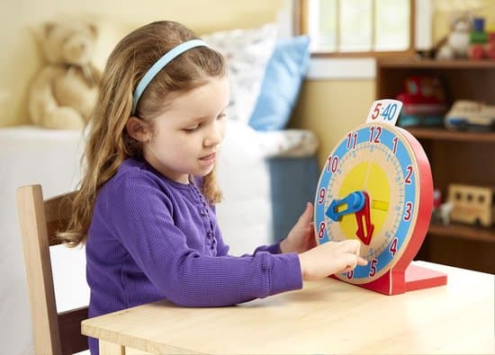 Girl practices with Melissa & Doug Turn & Tell Clock