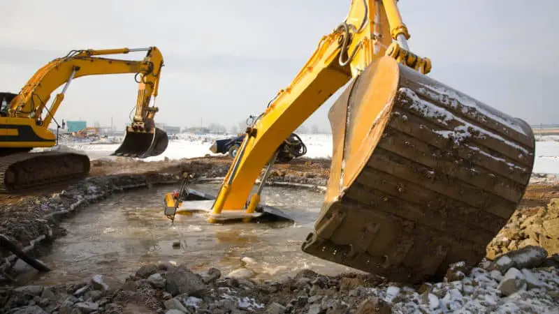 Excavator sinks into the mud