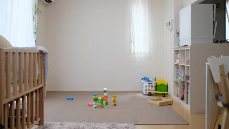 Toys on a rug in a demarcated play area