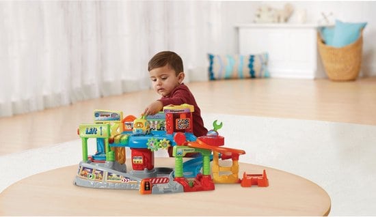 Best car garage for toddler boy- VTech Toet Toet Auto's Garage with little boy