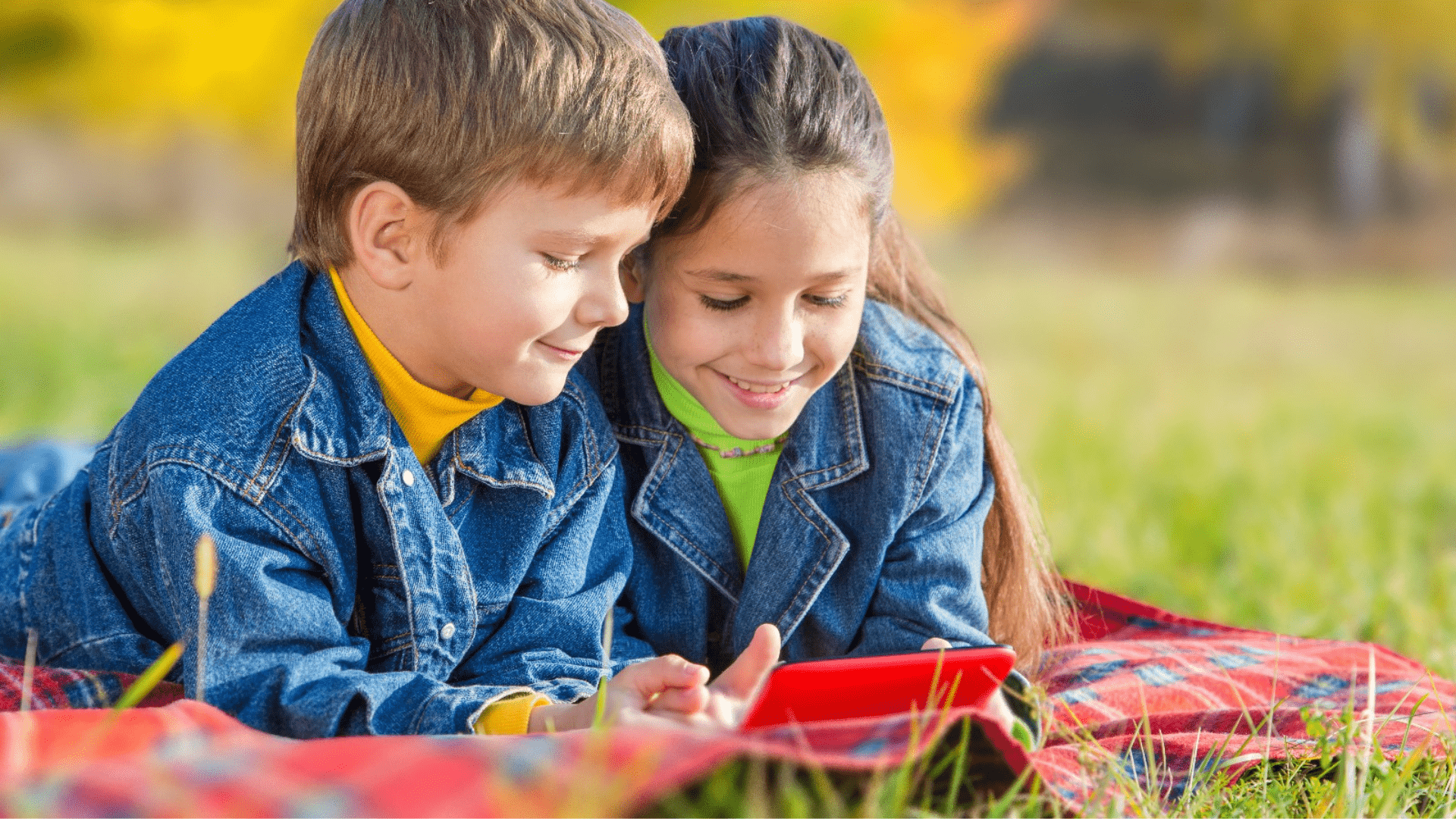 2 kids playing with a tablet