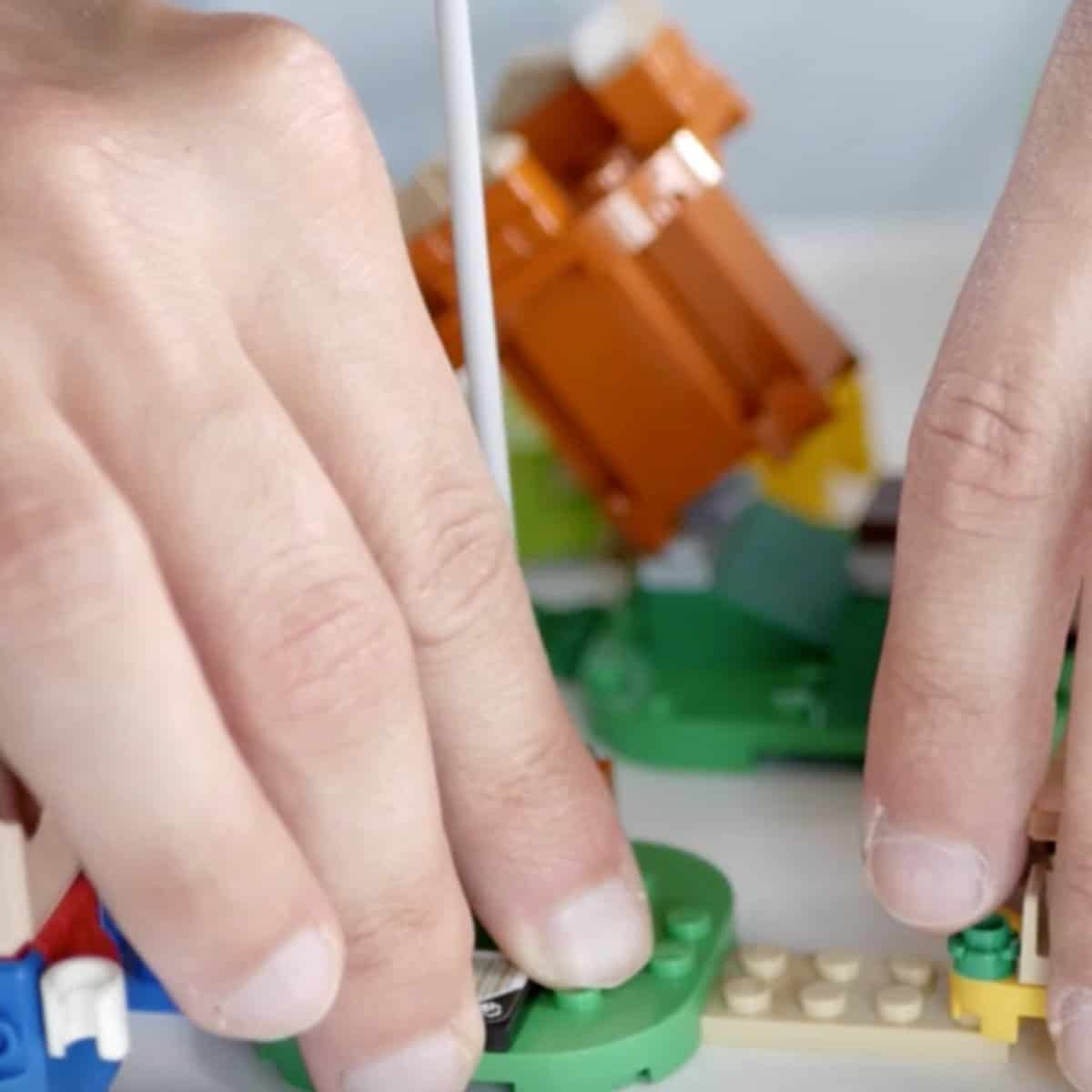 Closeup of connecting an expansion to Lego Mario
