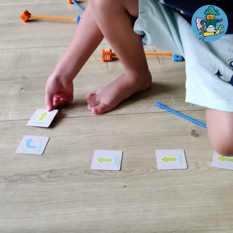 My son places the Botley coding cards on the floor